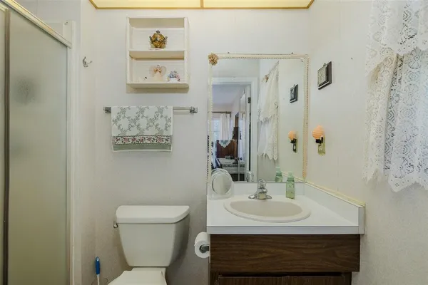 a bathroom with a sink a toilet and shower curtain
