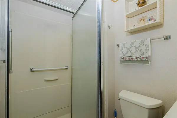a white toilet sitting next to a shower curtain