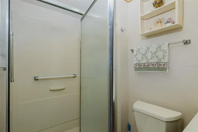 a white toilet sitting next to a shower curtain
