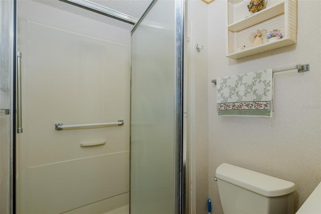 8015 San Fernando Drive Port Richey, FL 34668 - Photo 34 of 46 a white toilet sitting next to a shower curtain