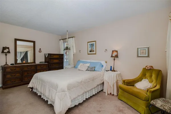 a bedroom with a bed and couch