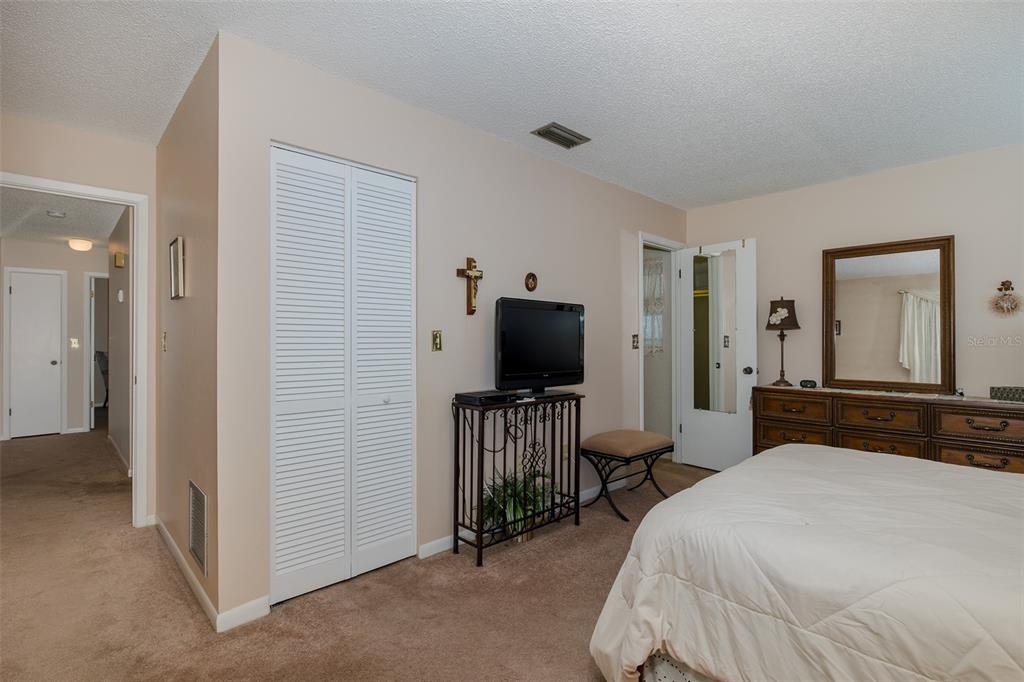 8015 San Fernando Drive Port Richey, FL 34668 - Photo 36 of 46 a bedroom with a bed and a flat tv screen on wall