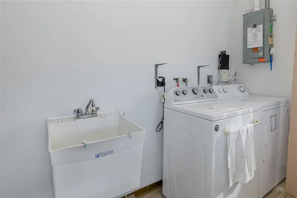a utility room with sink dryer and washer