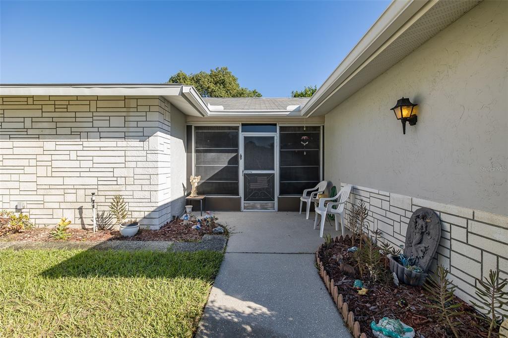 8015 San Fernando Drive Port Richey, FL 34668 - Photo 7 of 46 a front view of a house with garden
