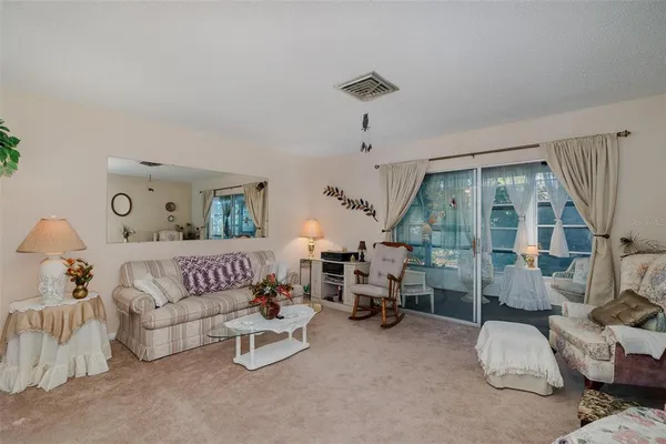 a bedroom with furniture and a large window