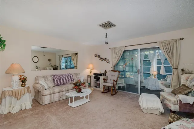 a bedroom with furniture and a large window