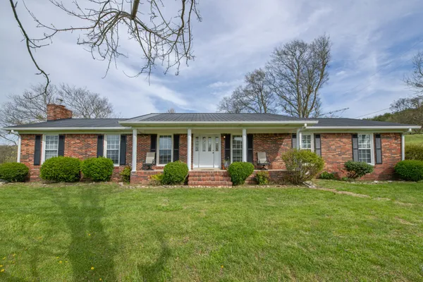 a front view of a house with a yard and porch