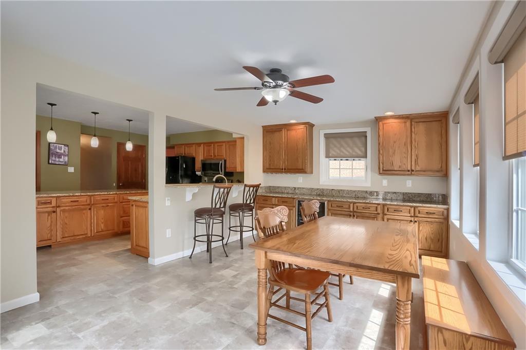 105 Blue Ridge Drive Cranberry Township, PA 16066 - Photo 12 of 50 a kitchen with a table chairs refrigerator and microwave