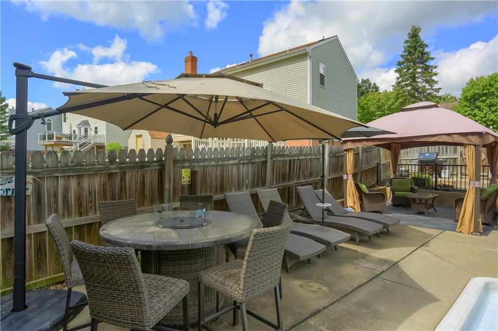 105 Blue Ridge Drive Cranberry Township, PA 16066 - Photo 40 of 50 a view of a patio with a table and chairs under an umbrella