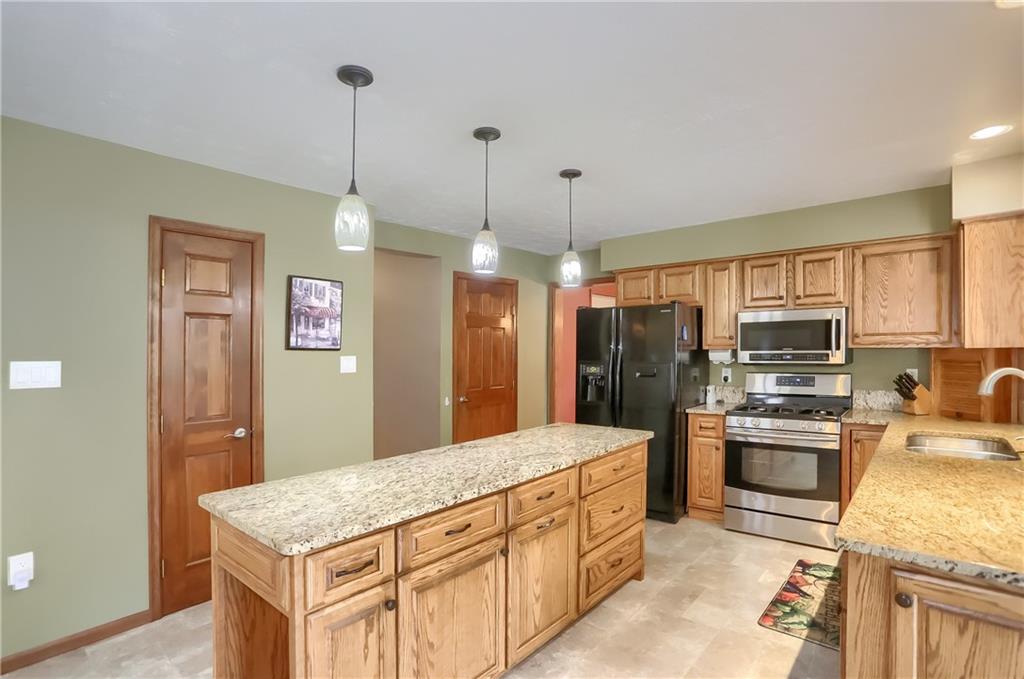 105 Blue Ridge Drive Cranberry Township, PA 16066 - Photo 9 of 50 a kitchen with stainless steel appliances granite countertop a sink refrigerator and cabinets