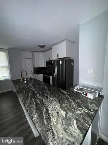 a kitchen with a refrigerator and a stove