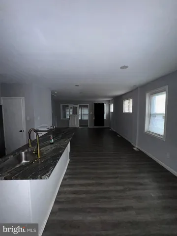 a kitchen with granite countertop a sink and cabinets
