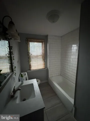 a white bath tub sitting next to a window