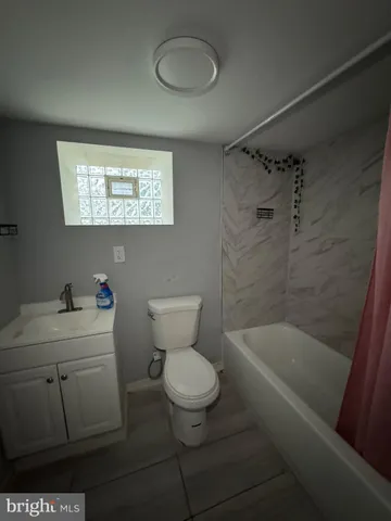 a bathroom with a toilet a sink and bathtub