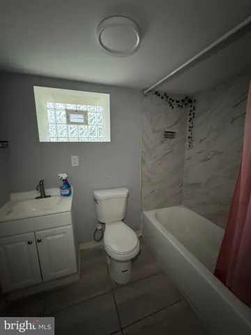a bathroom with a toilet a sink and bathtub