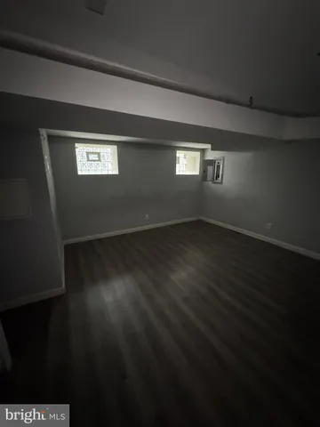 a view of wooden floor and a window in a room