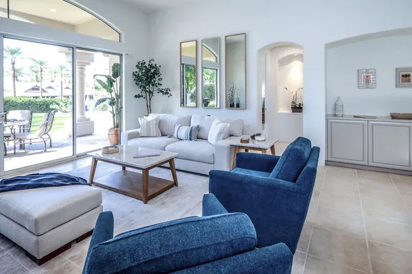 a living room with furniture and a large window