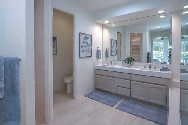 a spacious bathroom with a shower sink and mirror