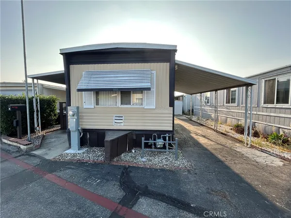 a view of a house with a yard and sitting area