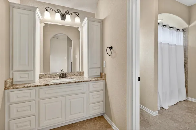 a bathroom with a sink mirror and vanity