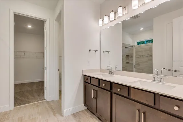 a bathroom with a sink double vanity and a mirror