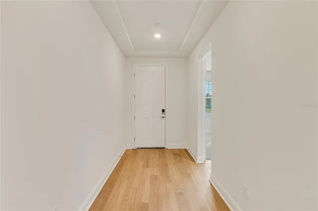 a view of a room with wooden floor and white walls