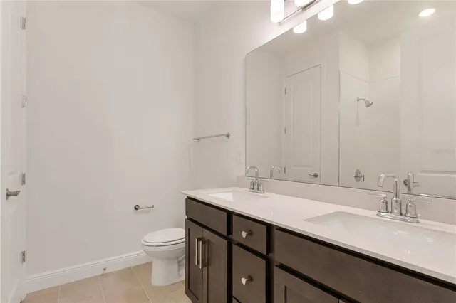 a bathroom with a sink a toilet and a mirror