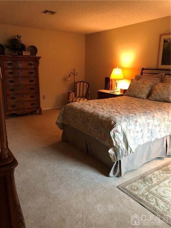 564 B Ardmore Road Monroe Township, NJ 08831 - Photo 16 of 26 a bedroom with a bed and a cabinets