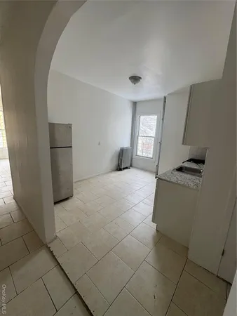 a kitchen with a refrigerator and a stove top oven