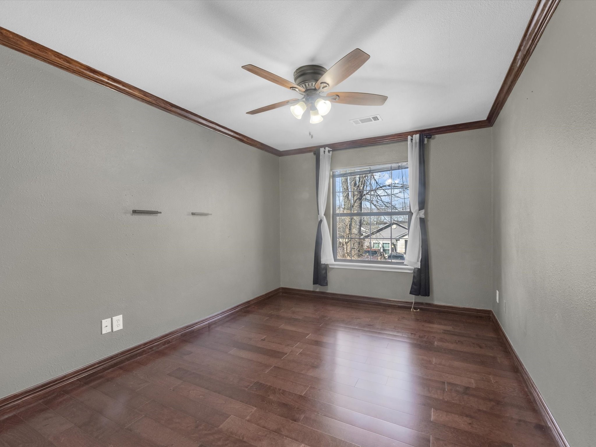 8906 Intervale Street Houston, TX 77075 - Photo 13 of 21 a view of an empty room with wooden floor and a window