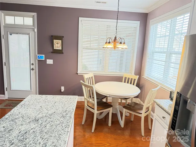 a kitchen with granite countertop a refrigerator stove and microwave
