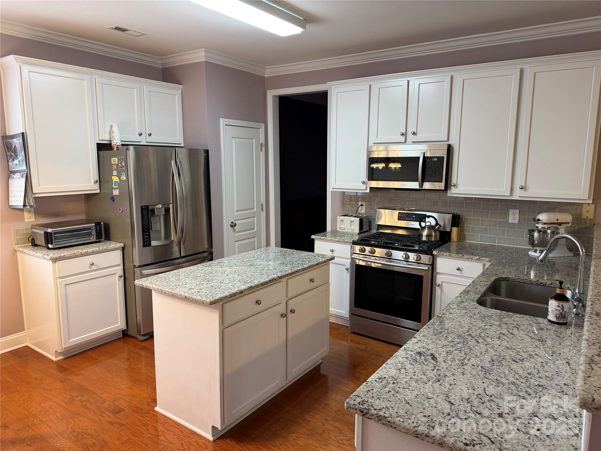 10219 Caldwell Depot Road Cornelius, NC 28031 - Photo 18 of 42 a kitchen with granite countertop a refrigerator stove and sink