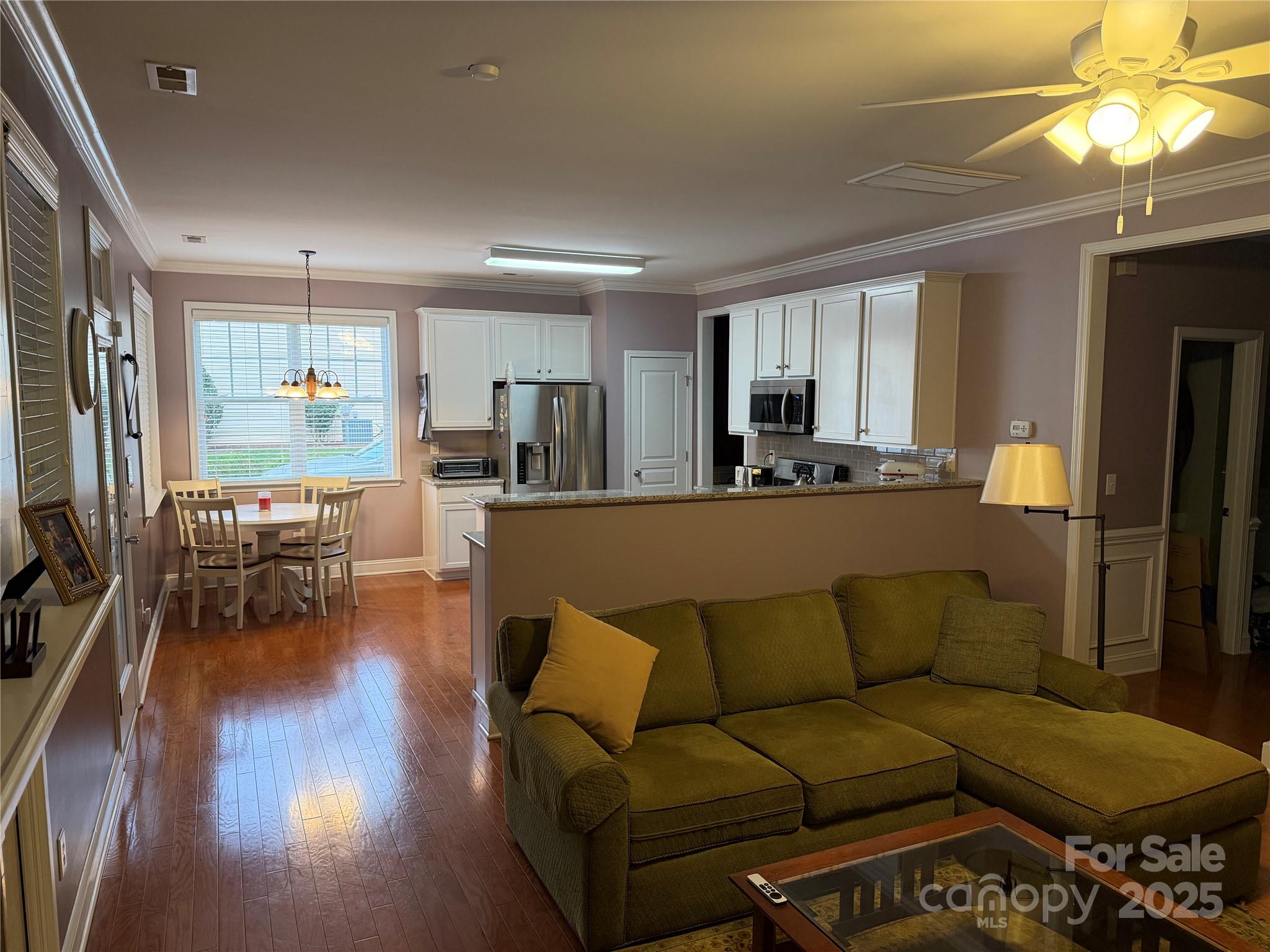 10219 Caldwell Depot Road Cornelius, NC 28031 - Photo 26 of 42 a living room with furniture and a large window