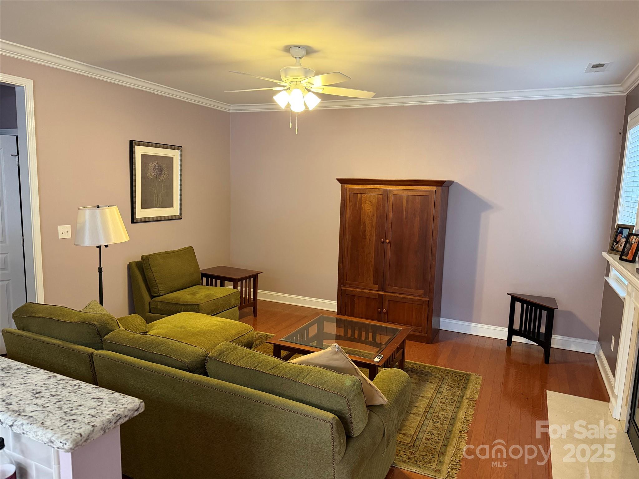 10219 Caldwell Depot Road Cornelius, NC 28031 - Photo 27 of 42 a living room with furniture and a chandelier