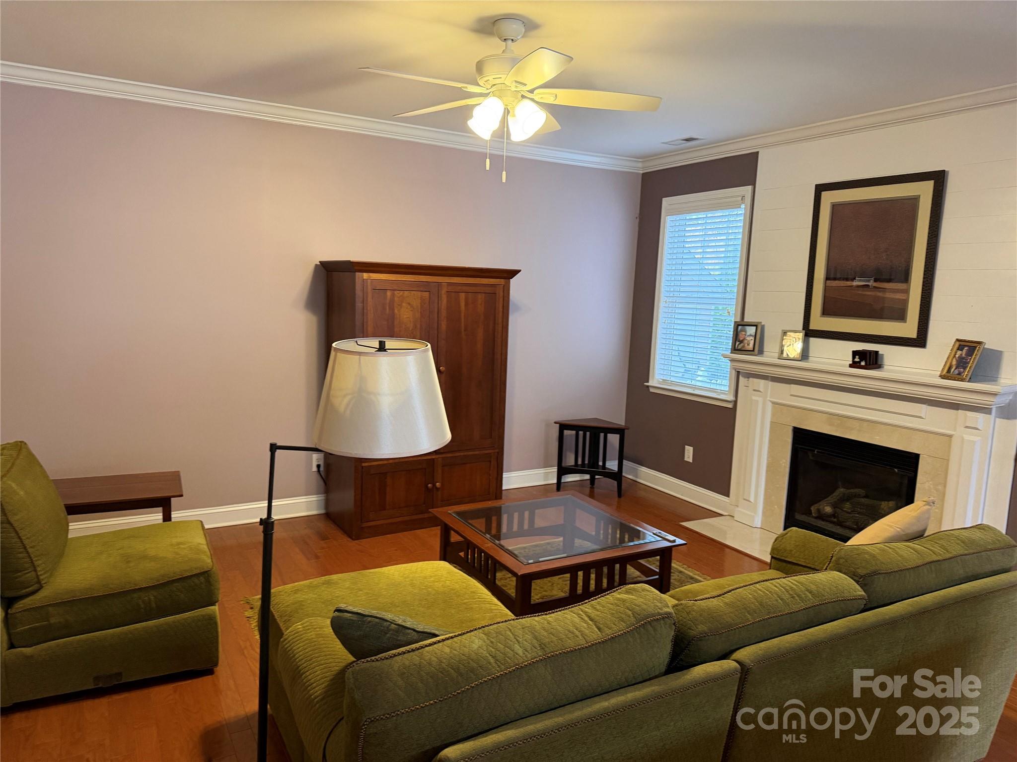 10219 Caldwell Depot Road Cornelius, NC 28031 - Photo 28 of 42 a living room with furniture and a fireplace