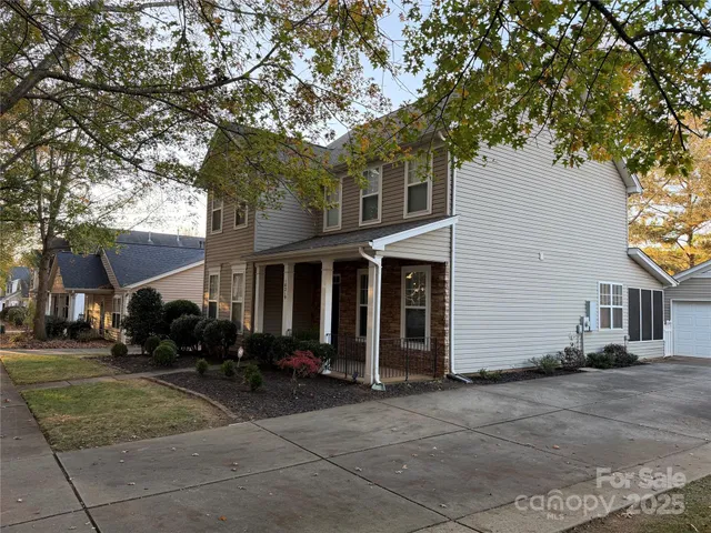a front view of house with yard and trees around