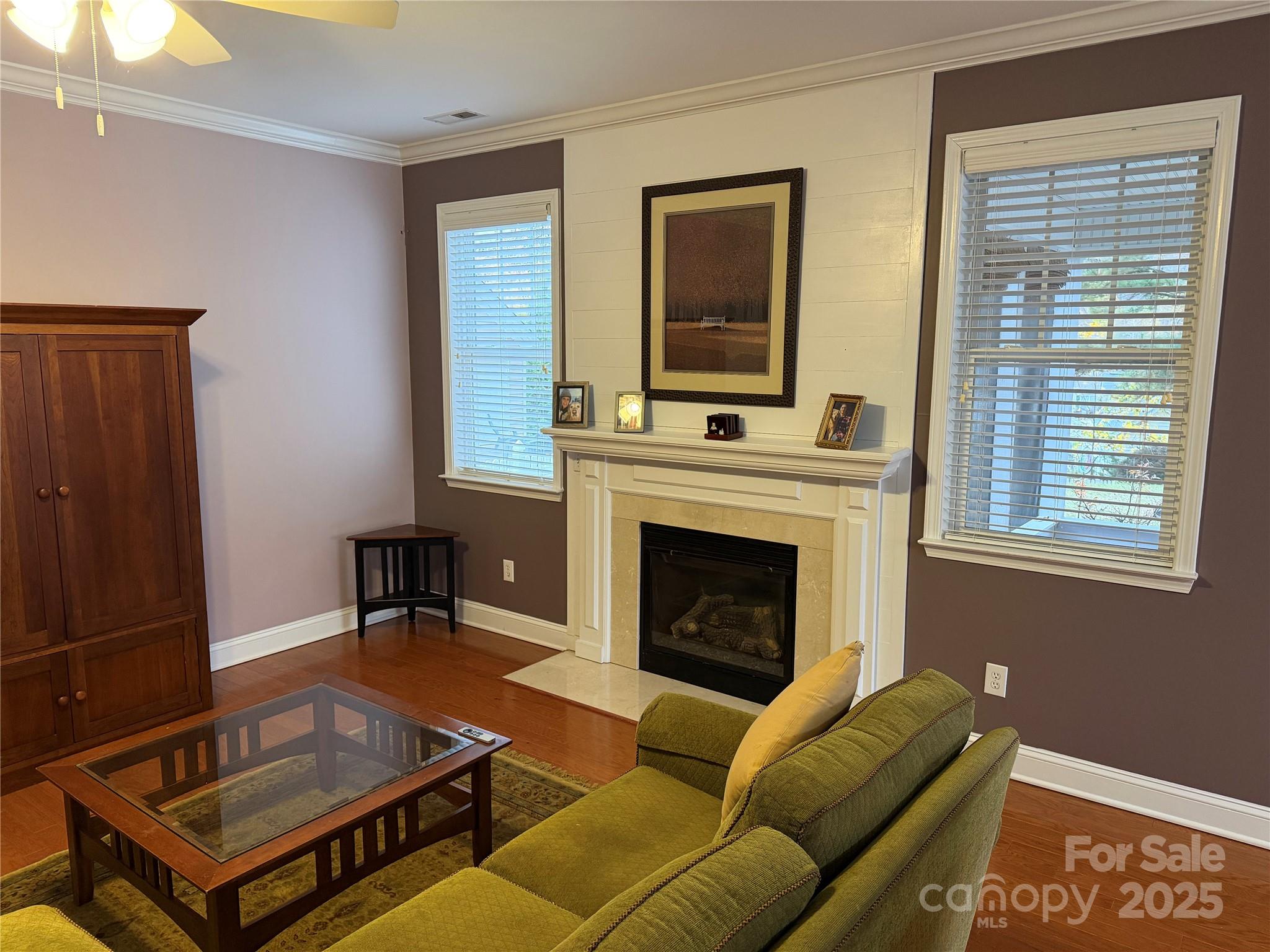 10219 Caldwell Depot Road Cornelius, NC 28031 - Photo 31 of 42 a living room with furniture a flat screen tv and a fireplace