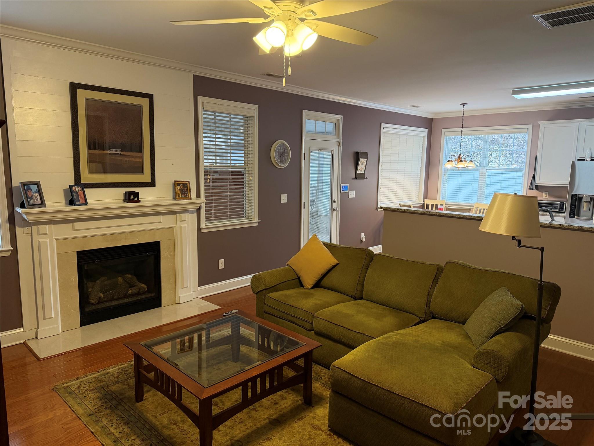 10219 Caldwell Depot Road Cornelius, NC 28031 - Photo 32 of 42 a living room with furniture a flat screen tv and a fireplace