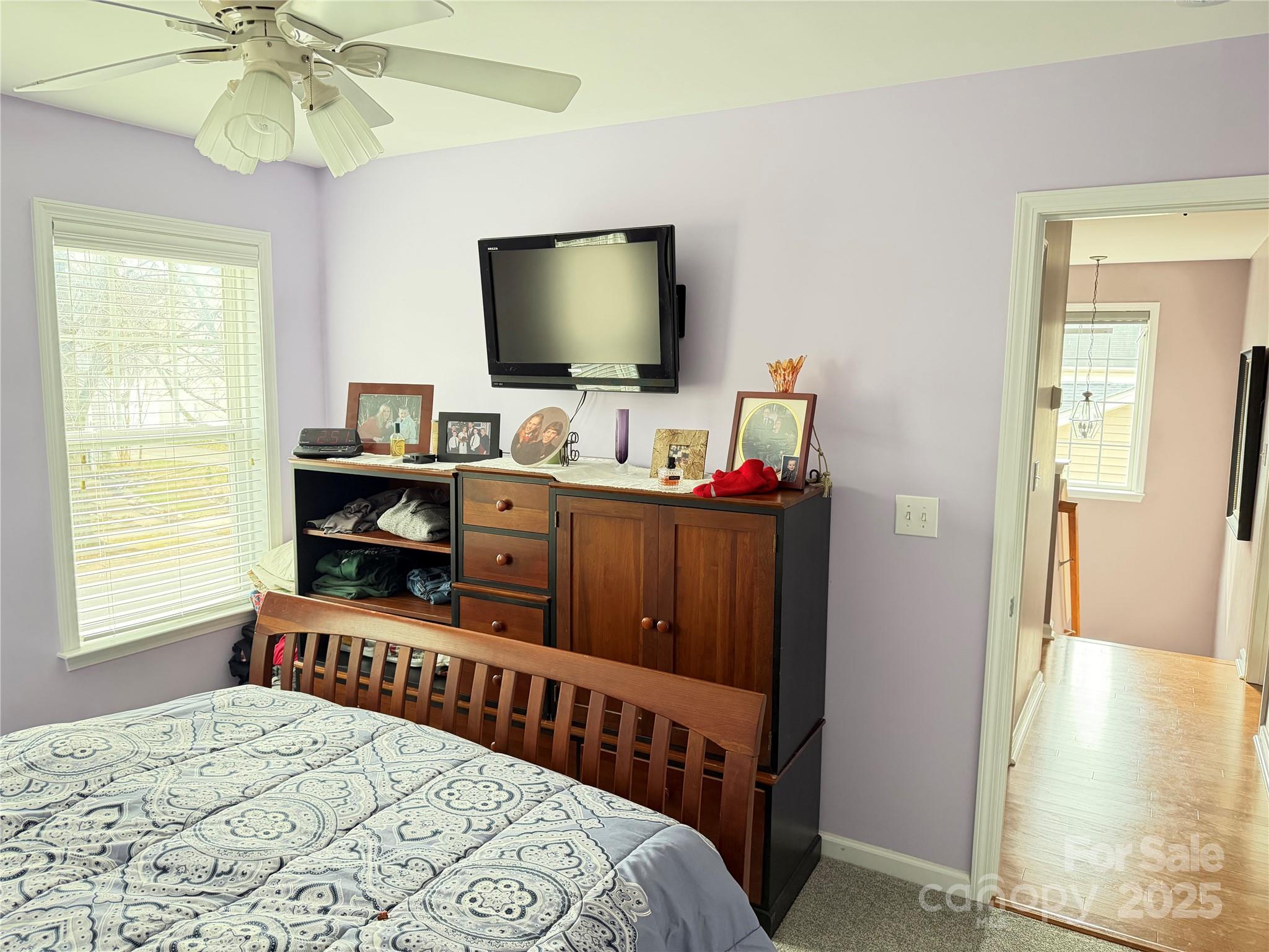 10219 Caldwell Depot Road Cornelius, NC 28031 - Photo 33 of 42 a bedroom with a bed and a flat screen tv