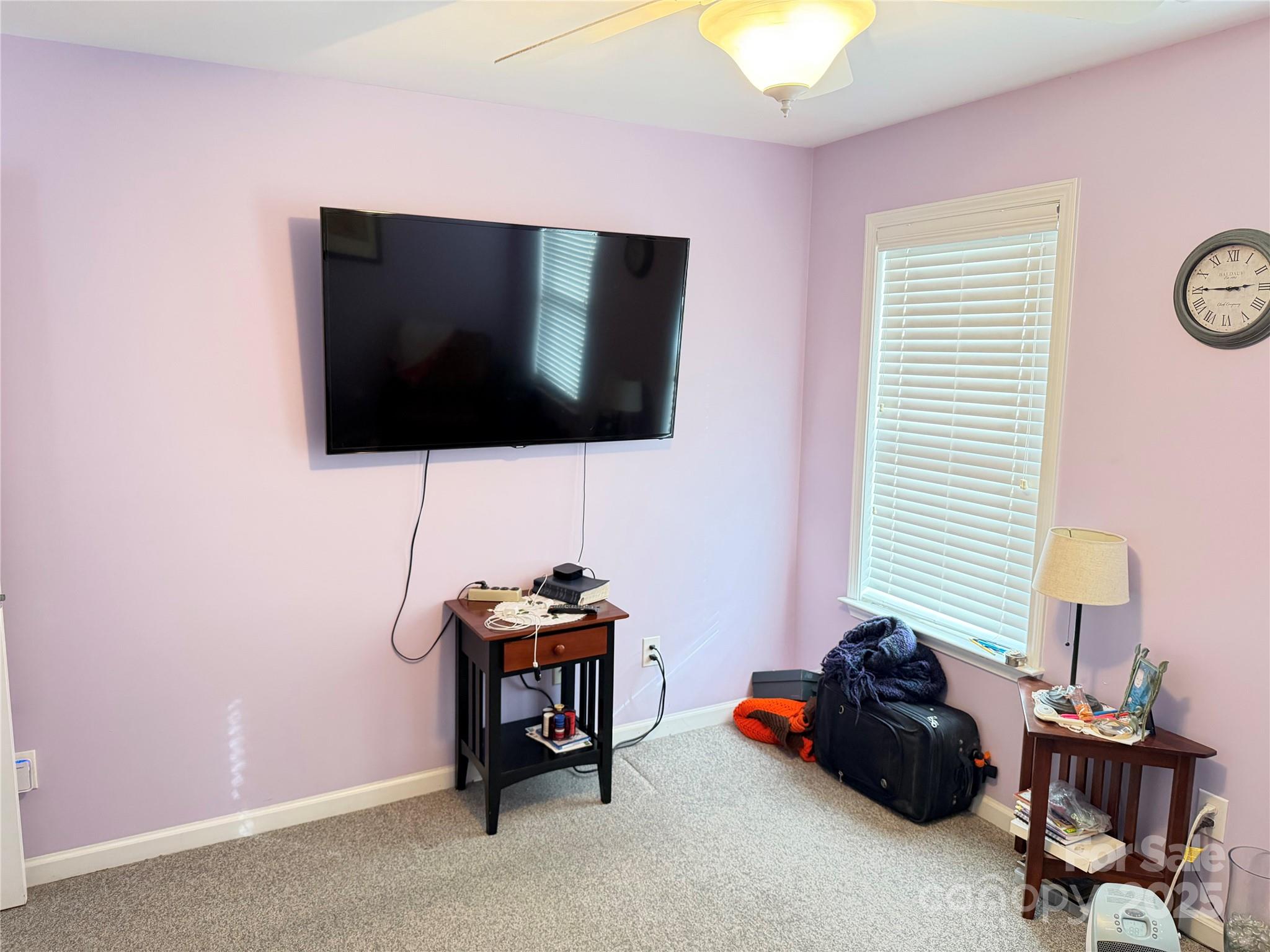 10219 Caldwell Depot Road Cornelius, NC 28031 - Photo 34 of 42 a living room with furniture and a flat screen tv