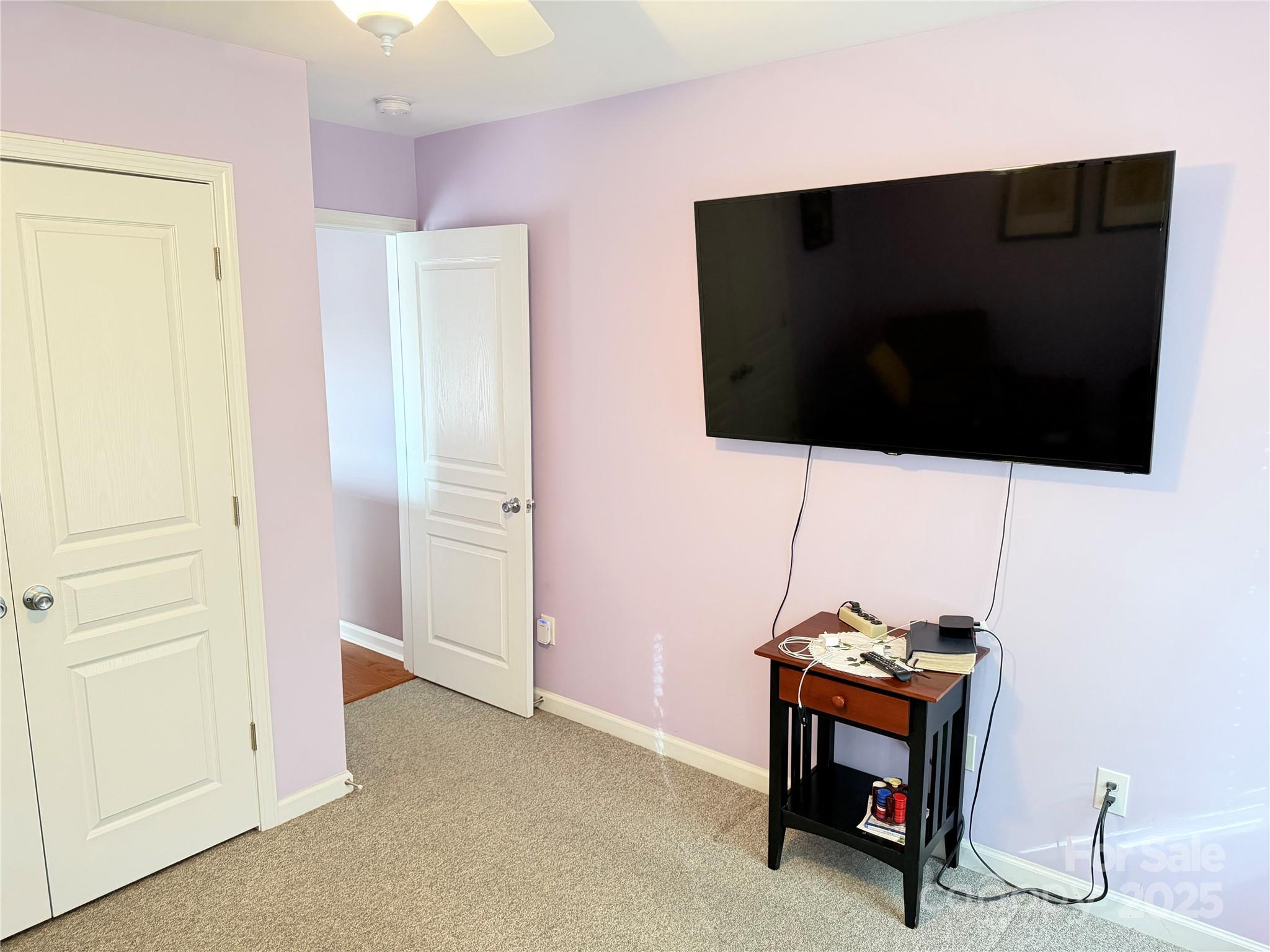 10219 Caldwell Depot Road Cornelius, NC 28031 - Photo 36 of 42 a living room with a flat screen tv and a dresser