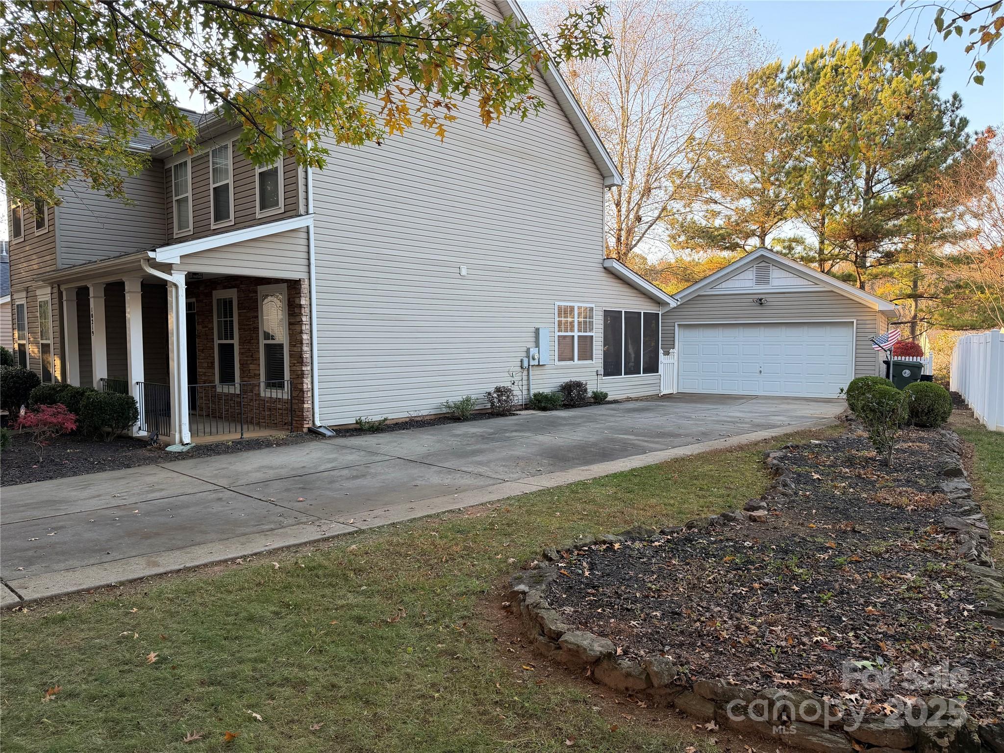 10219 Caldwell Depot Road Cornelius, NC 28031 - Photo 4 of 42 a front view of a house with a yard and garage