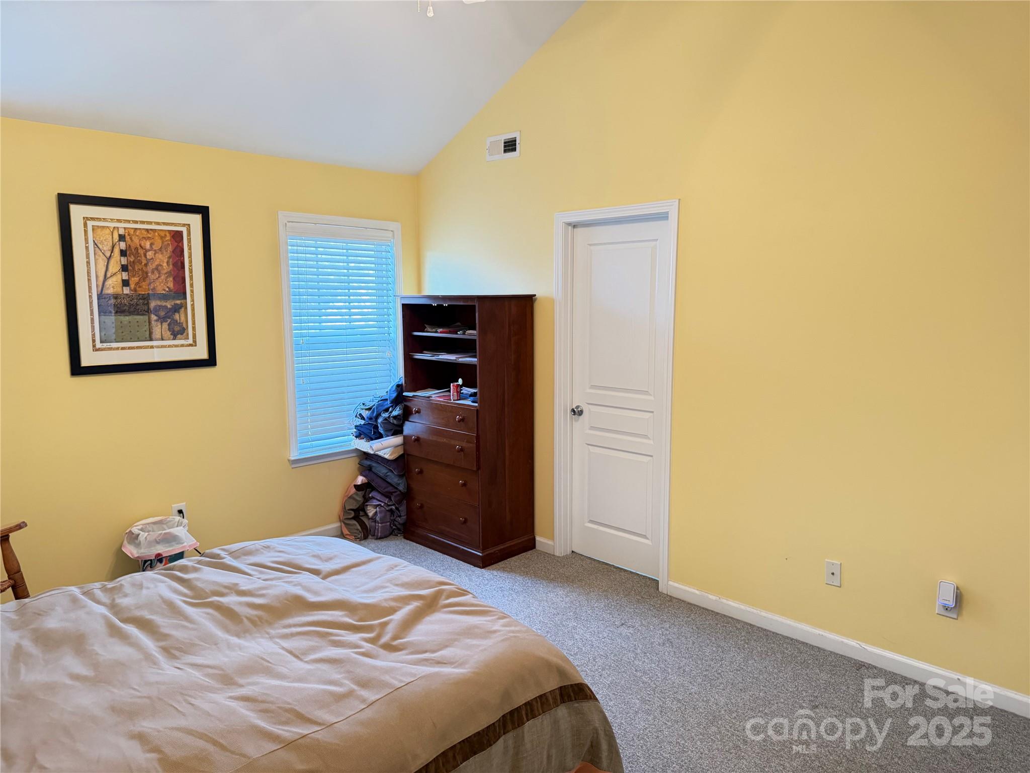 10219 Caldwell Depot Road Cornelius, NC 28031 - Photo 41 of 42 a bedroom with a bed and a wall painting