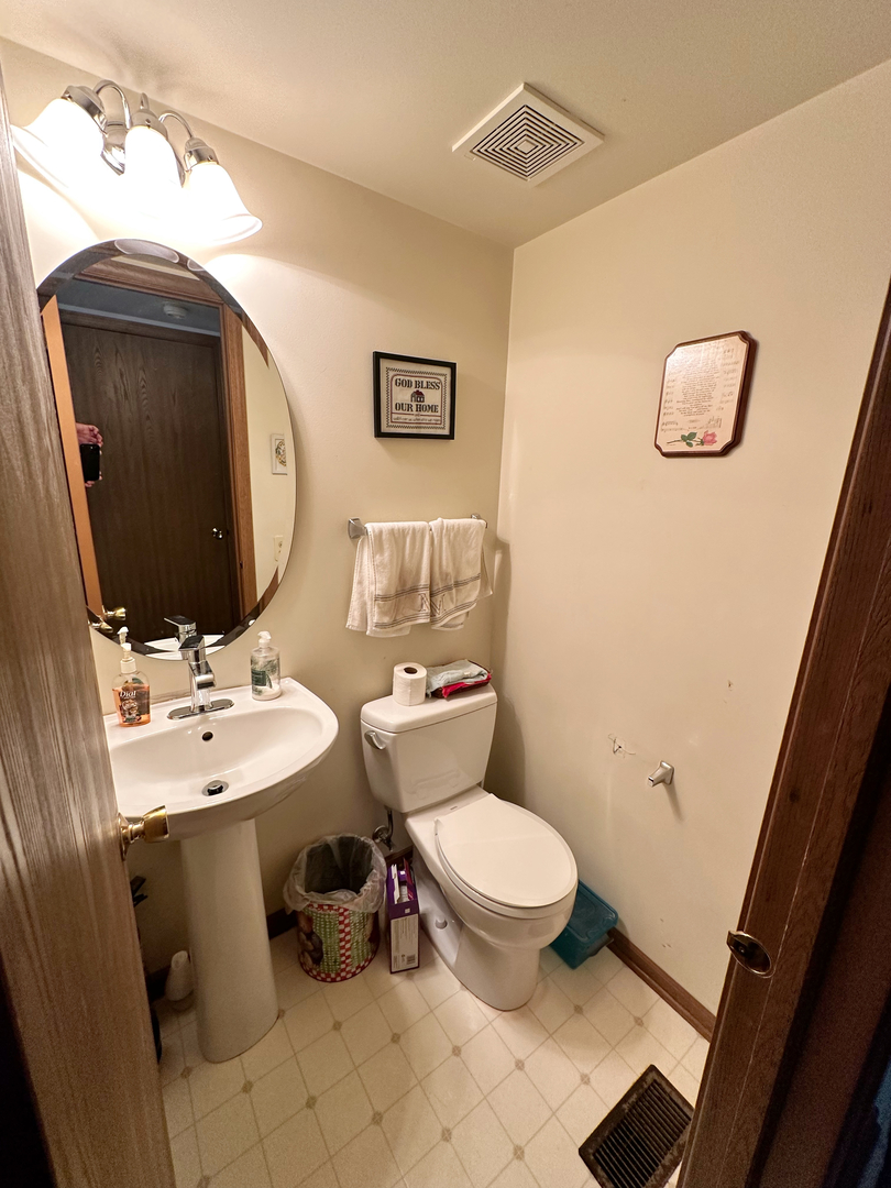 306 Cane Garden Circle Aurora, IL 60504 - Photo 6 of 13 a bathroom with a toilet sink and mirror
