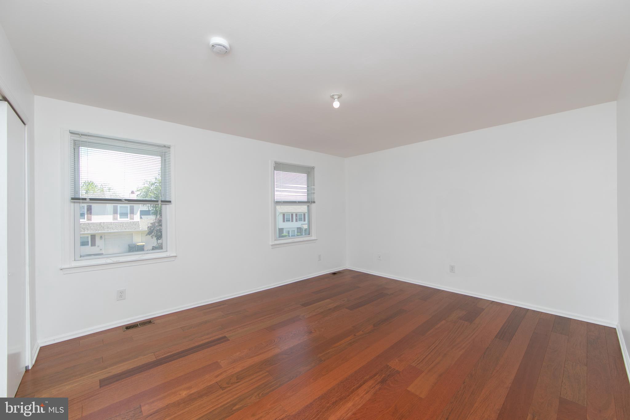 3007 Rampart Road Bensalem, PA 19020 - Photo 30 of 48 an empty room with wooden floor and windows