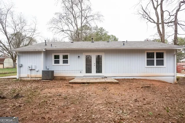 a house that has a tree in front of the house