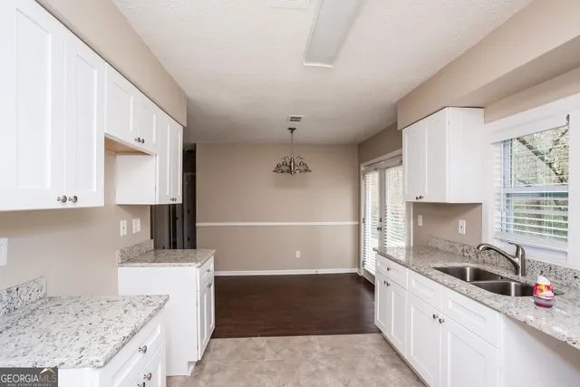 a kitchen with a sink stove and cabinets