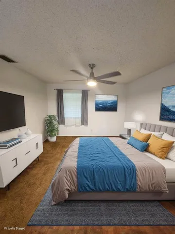 a bedroom with a bed and a flat screen tv
