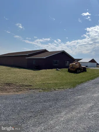 a view of an house with backyard space and a fireplace