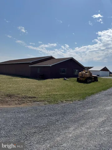 a view of an house with backyard space and a fireplace